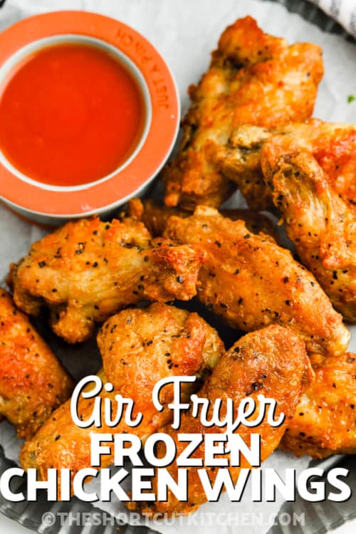 Air fryer chicken wings on a plate with dip with writing