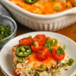 John Wayne Casserole on a plate with tomatoes and Jalapenos