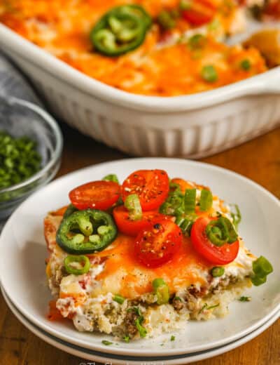 John Wayne Casserole on a plate with tomatoes and Jalapenos