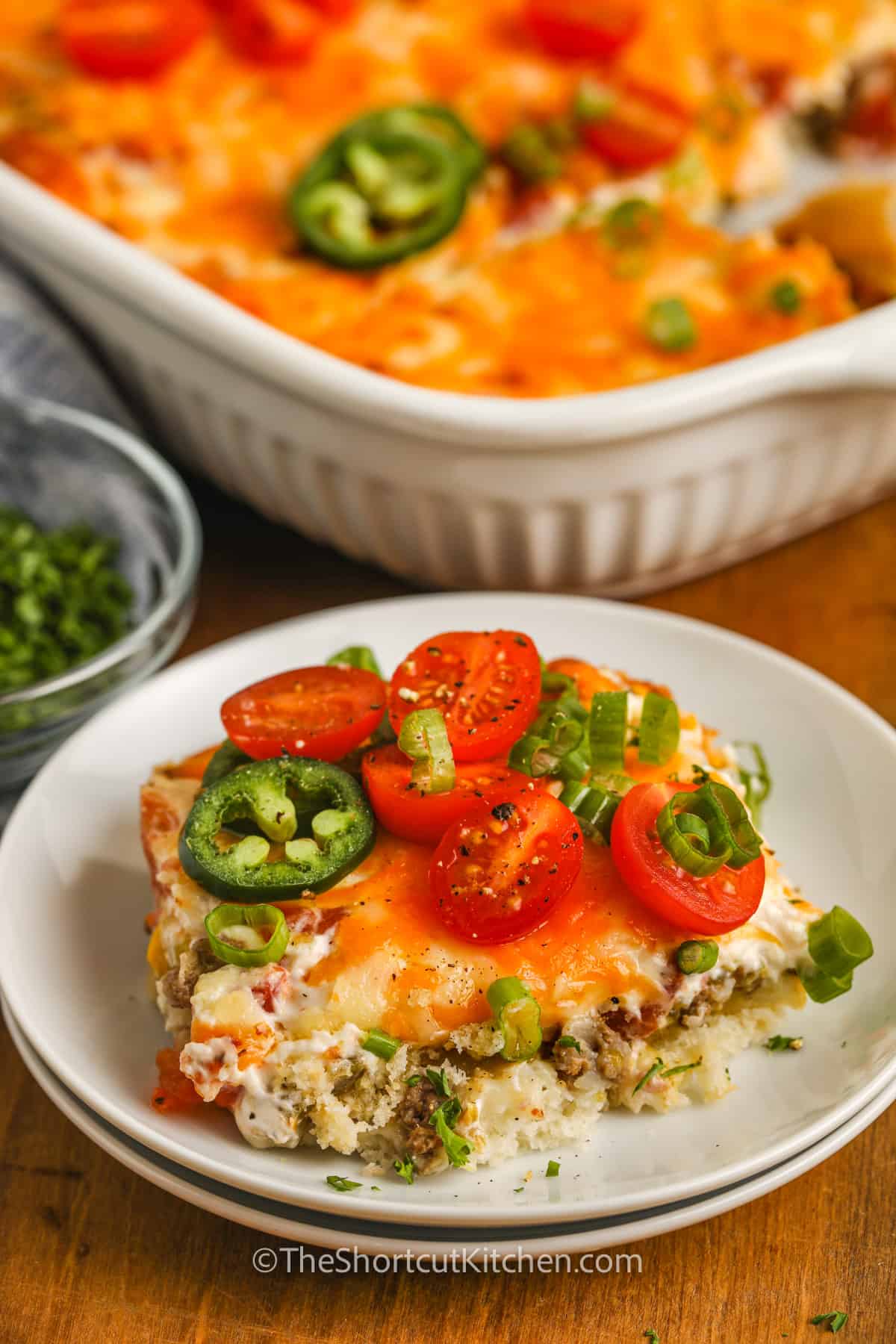 John Wayne Casserole on a plate with tomatoes and Jalapenos