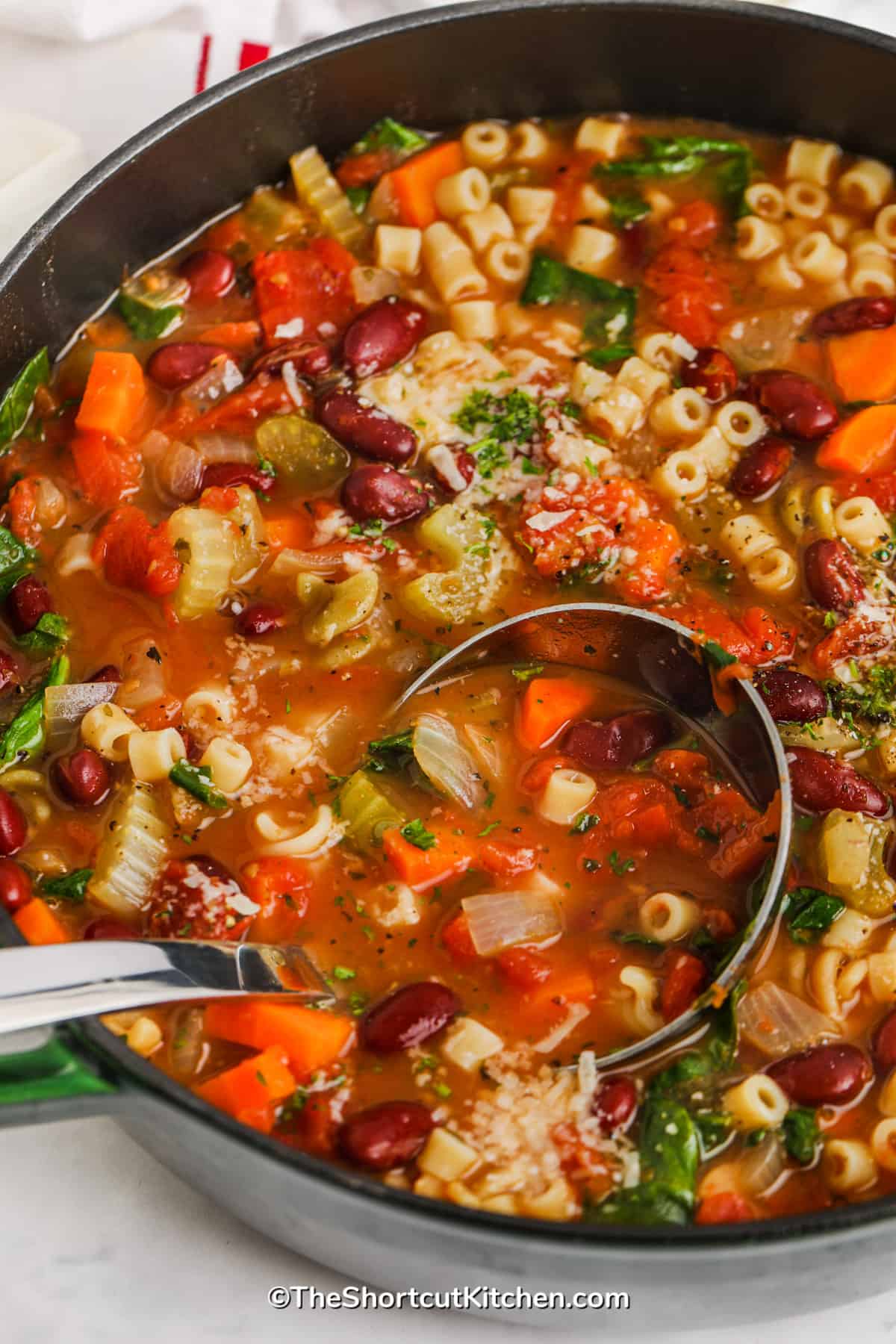 taking a spoon full out of a pot of Minestrone Soup Recipe