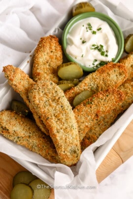 Oven Fried Pickles garnished with sliced pickles with dip