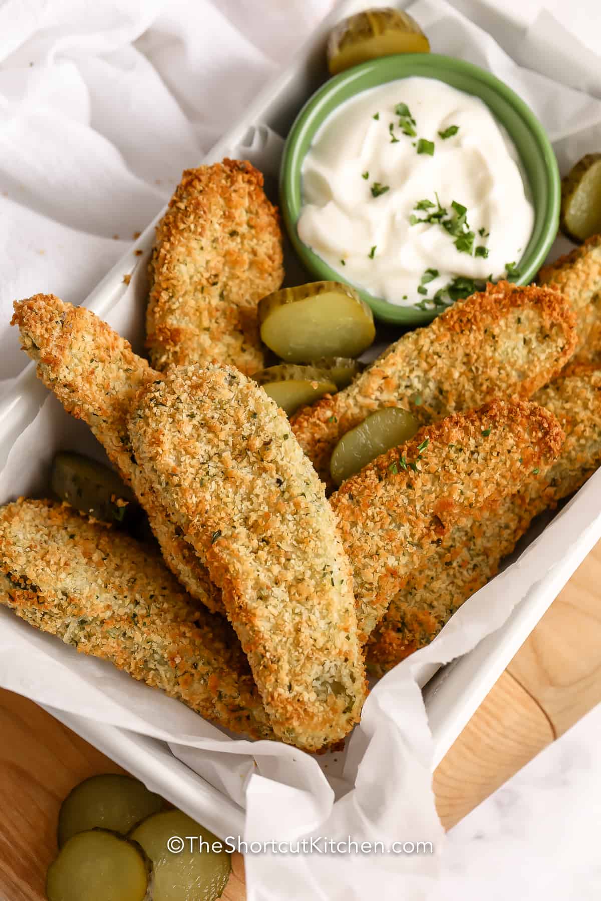 Oven Fried Pickles garnished with sliced pickles with dip