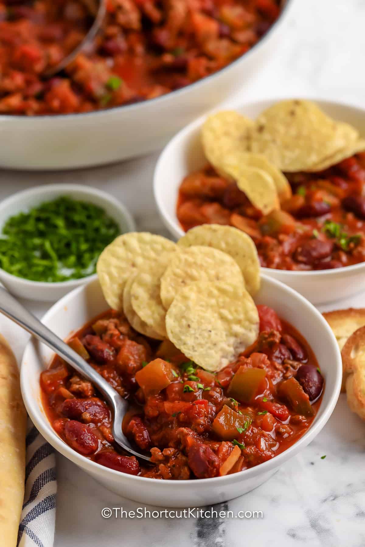 Two servings of chili with chips