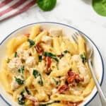 Tuscan Chicken Pasta in a bowl with a fork