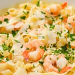 Easy Shrimp Alfredo prepared and served in a pan, garnished with fresh parsley