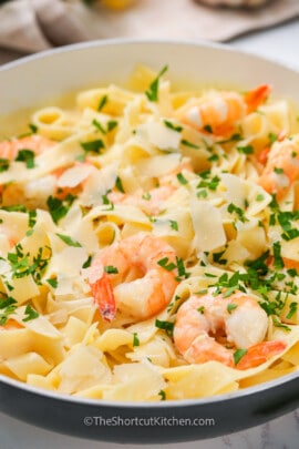Easy Shrimp Alfredo prepared and served in a pan, garnished with fresh parsley