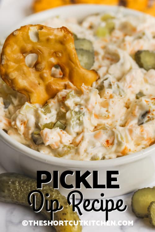 Pickle Dip being scoped with a pretzel cracker with a title