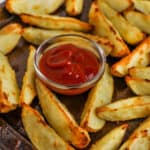 Close up of a oven baked potato wedges with ketchup