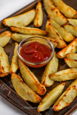 Close up of a oven baked potato wedges with ketchup