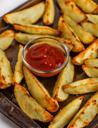 Close up of a oven baked potato wedges with ketchup