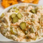 Dill Pickle Dip prepare in a serving dish with sliced pickles on top.