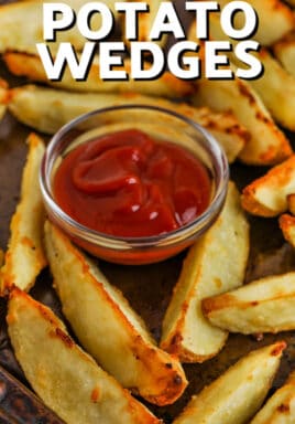 Oven baked potato wedges with ketchup with writing