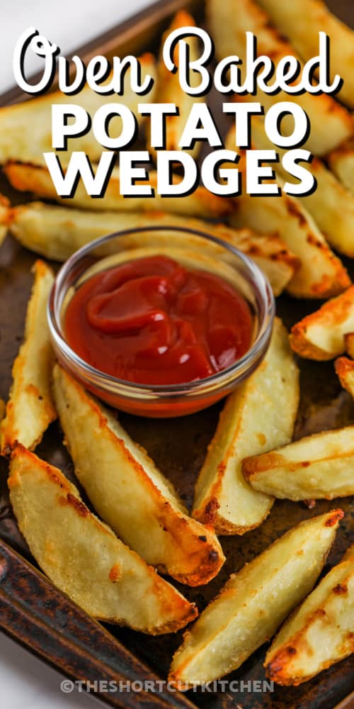 Oven baked potato wedges with ketchup with writing