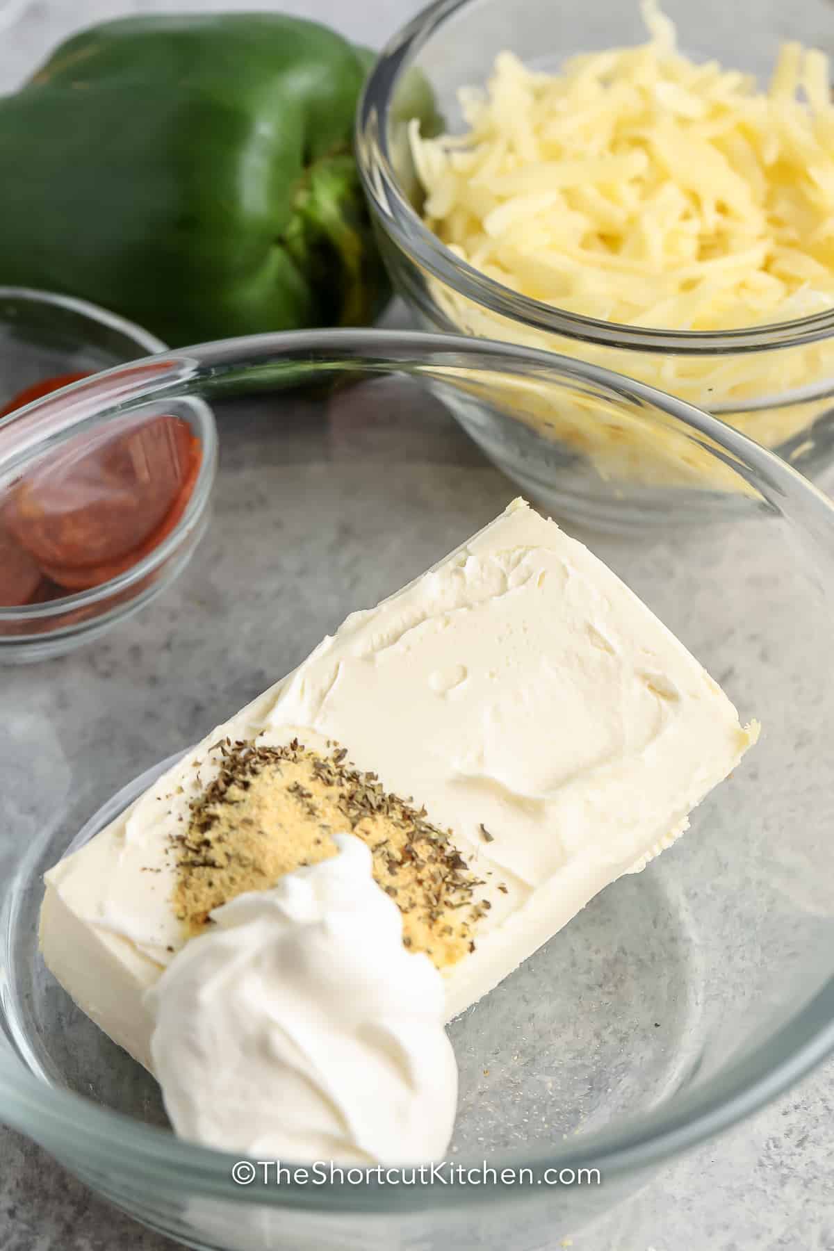 Cream cheese and sour cream in a bowl with spices