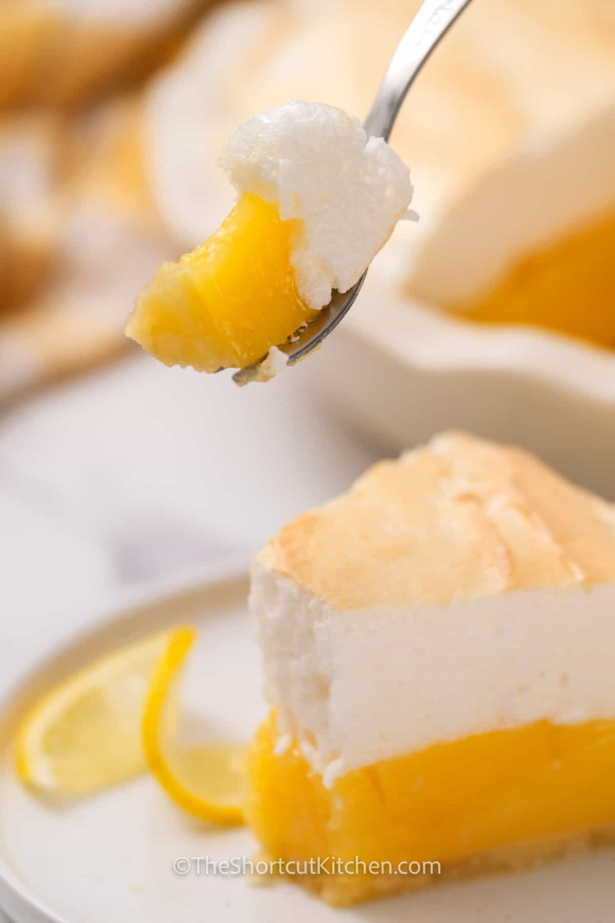A slice of lemon meringue pie on a plate