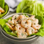 A bowl of shrimp salad served on lettuce