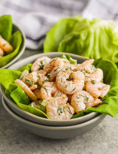 A bowl of shrimp salad served on lettuce