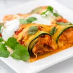 zucchini enchiladas on plate topped with cilantro