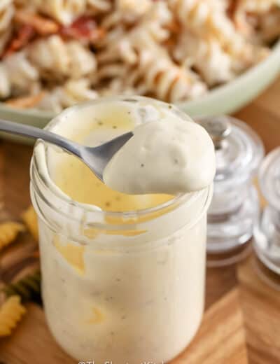 pasta salad dressing in a jar with a spoon
