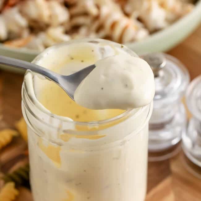 pasta salad dressing in a jar with a spoon