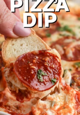 Cheesy Pizza Dip being scooped with a slice of baguette with a title