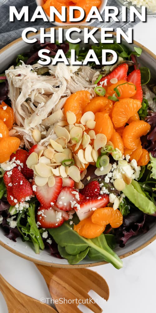 Mandarin Chicken Salad in a bowl with wooden utensils and writing