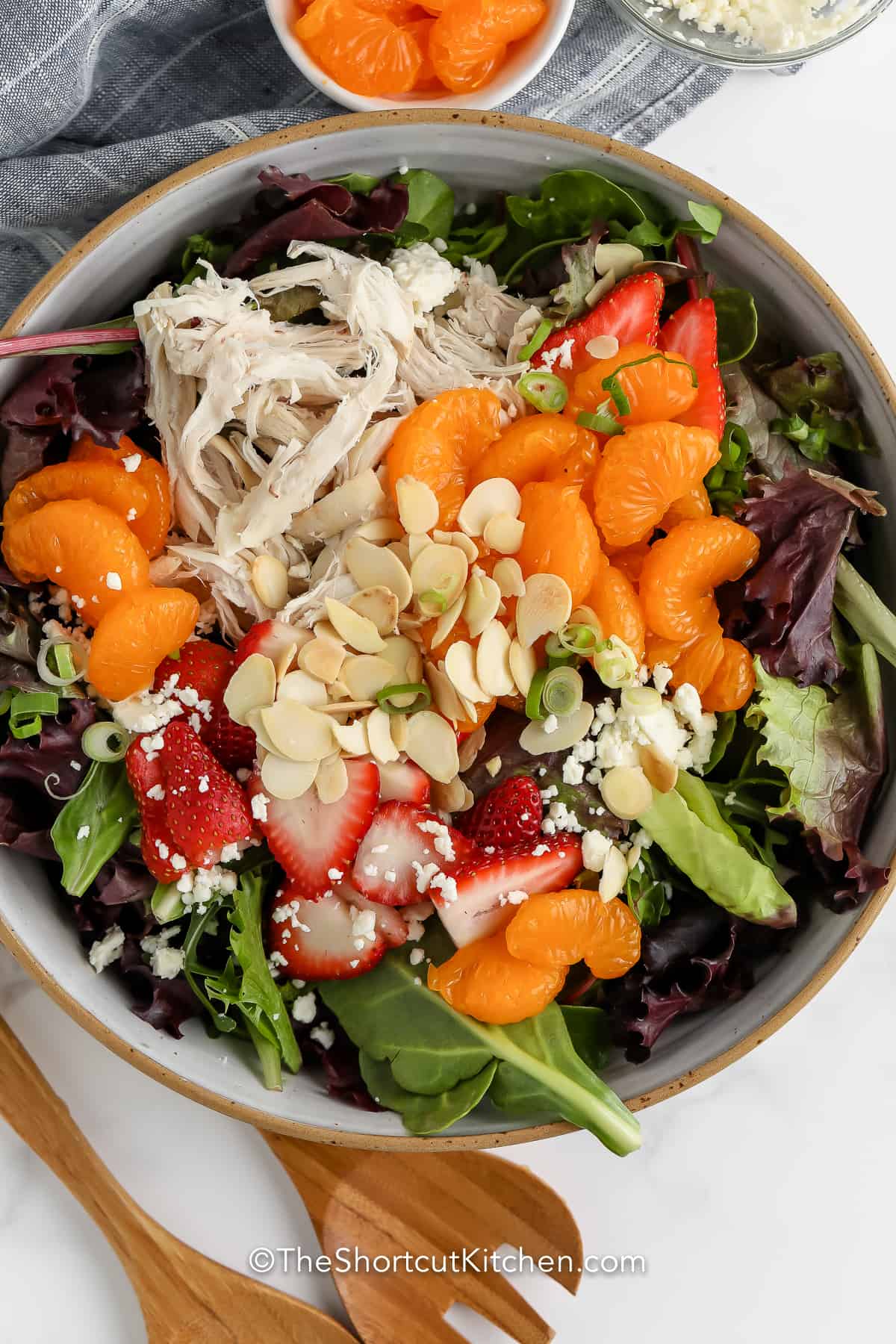 Mandarin Chicken Salad in a bowl with wooden utensils