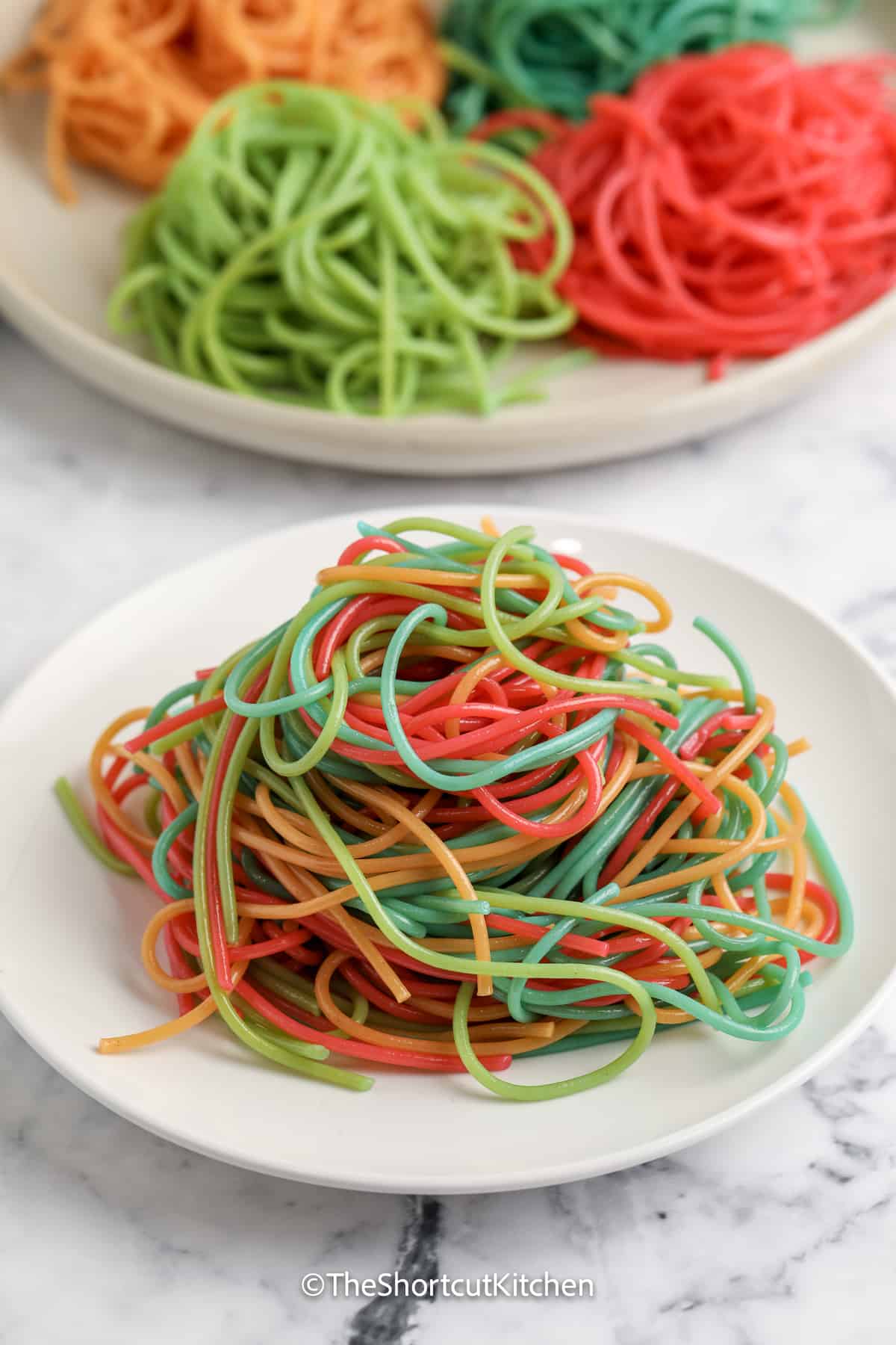 coloured spaghetti noodles on a plate