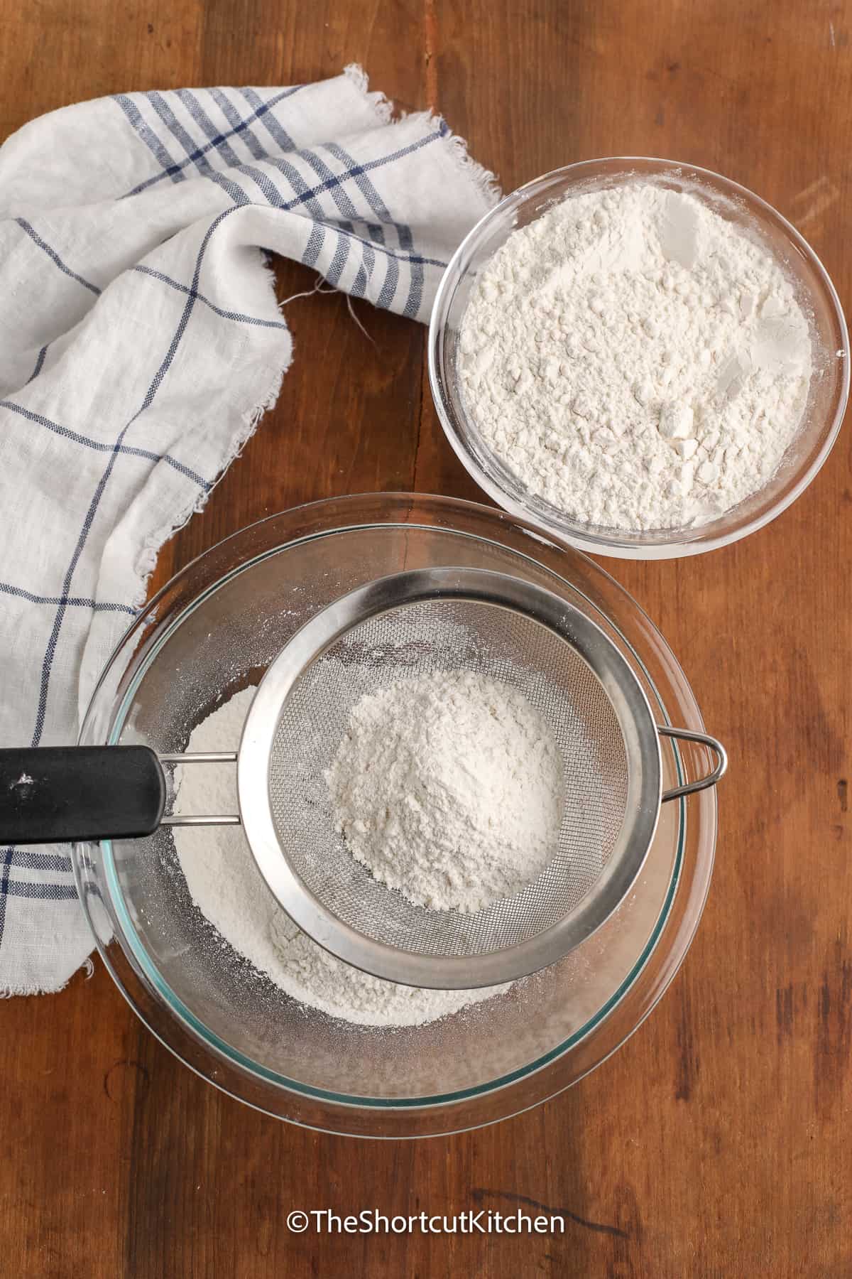 copycat bisquick ingredients being sifted into a bowl