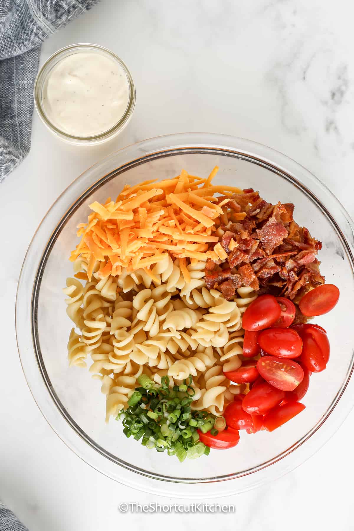 ingredients for bacon ranch pasta salad in a bowl