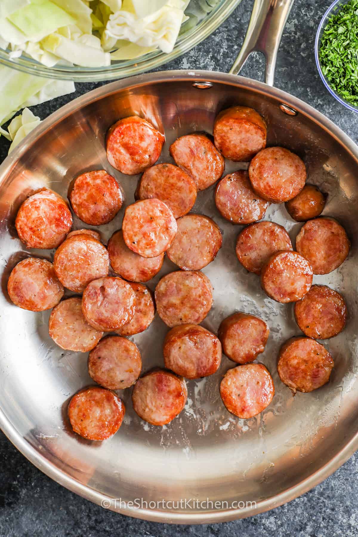 cooking sausage to make Fried Cabbage and Sausage