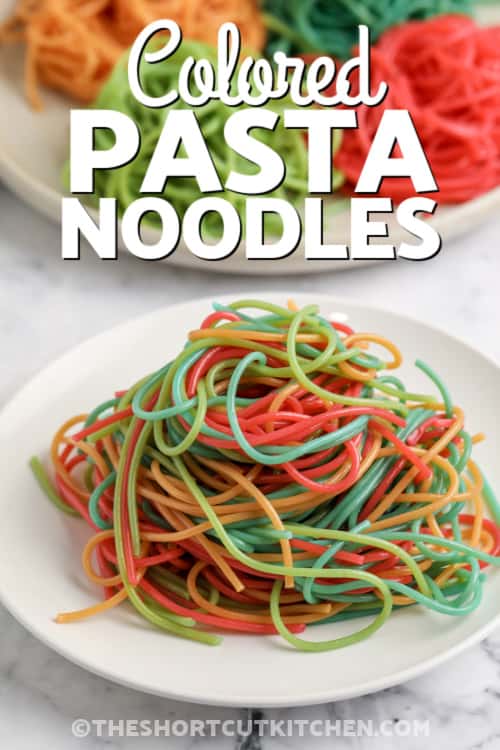 coloured spaghetti noodles on a plate with text