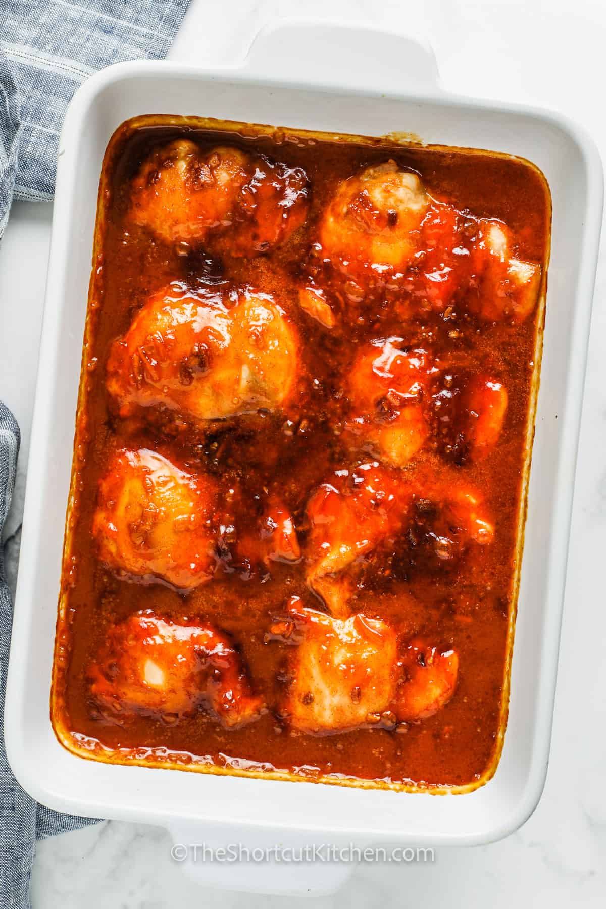 Make dinner easy with this one-pan apricot chicken recipe. Apricot jam and dressing bring the sweet-tart flavor, while onion soup mix adds savory flavor for a classic Russian chicken style bake. Use thighs, legs, or breasts and bake until tender and glossy. Optional add-ins like peppers, onions, or chili flakes make it customizable and family-friendly. #theshortcutkitchen cooked Apricot Chicken in the pan
