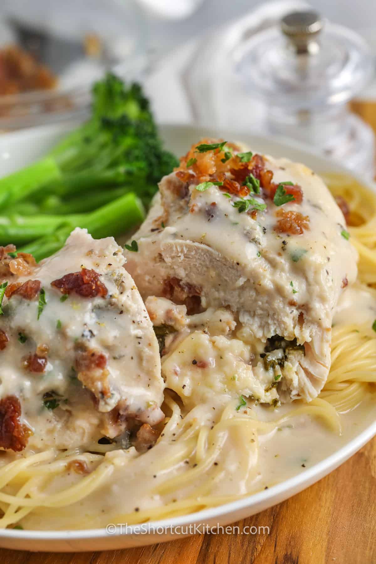 Crock Pot Chicken Florentine cut in half with spaghetti and broccoli