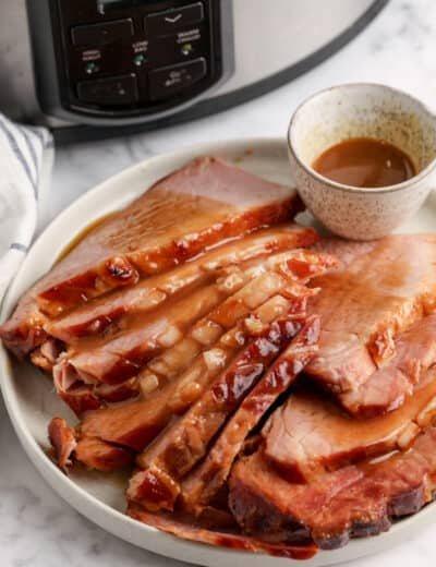 sliced ham on a plate topped with gravy