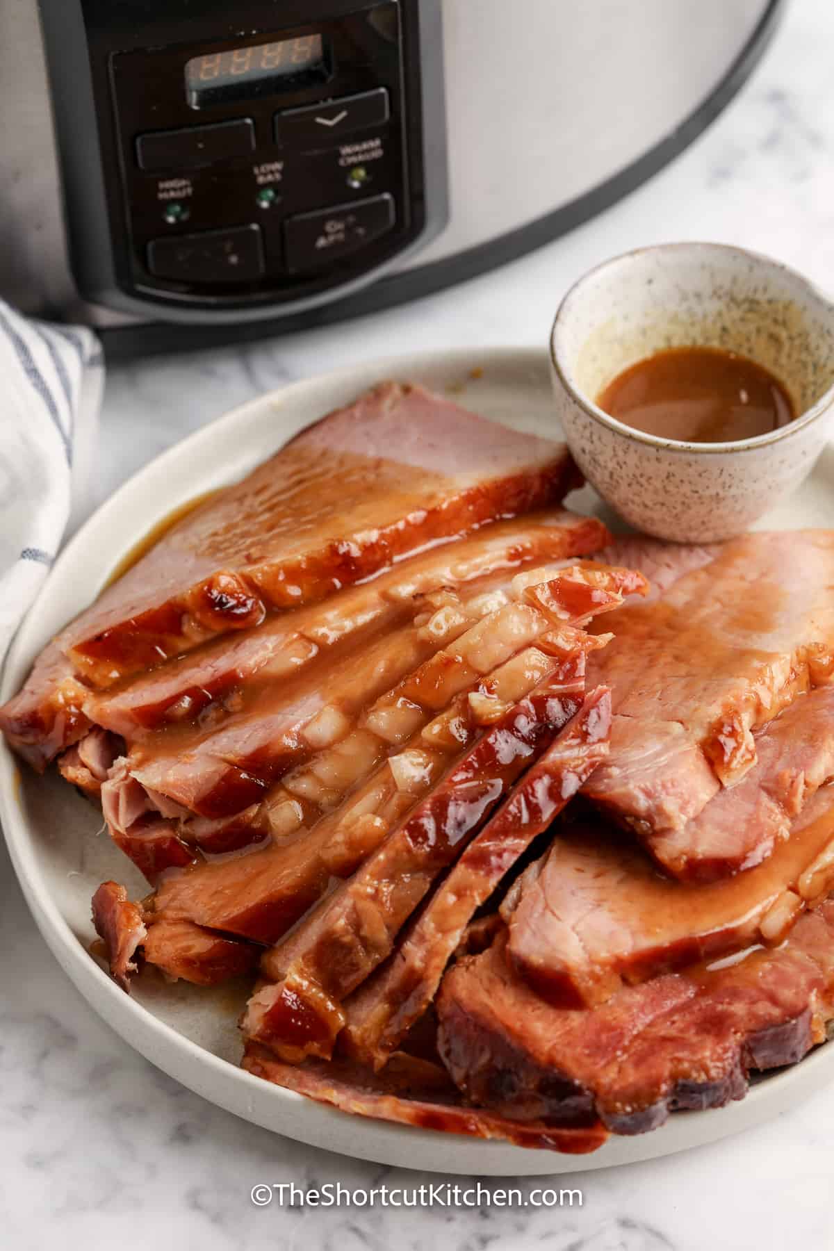 sliced ham on a plate topped with gravy