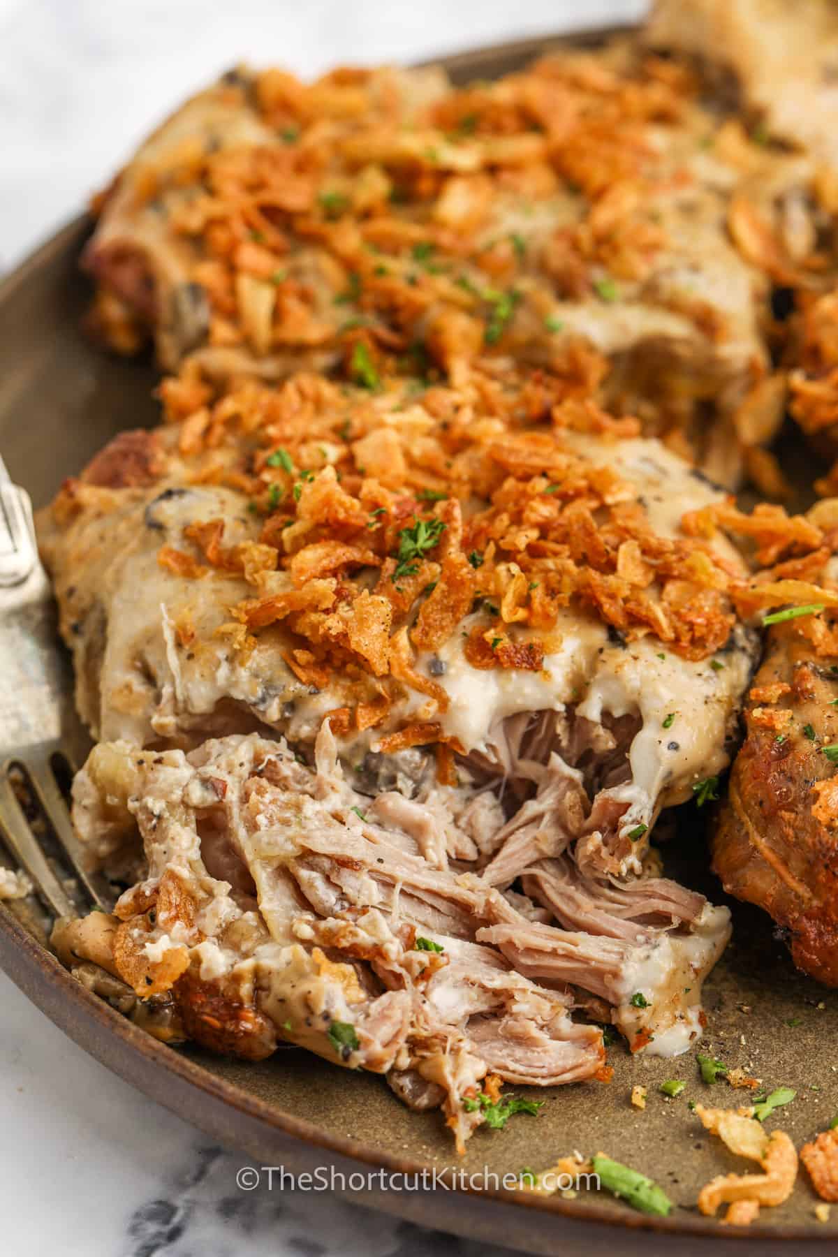 close up of French Onion Pork Chops with a fork