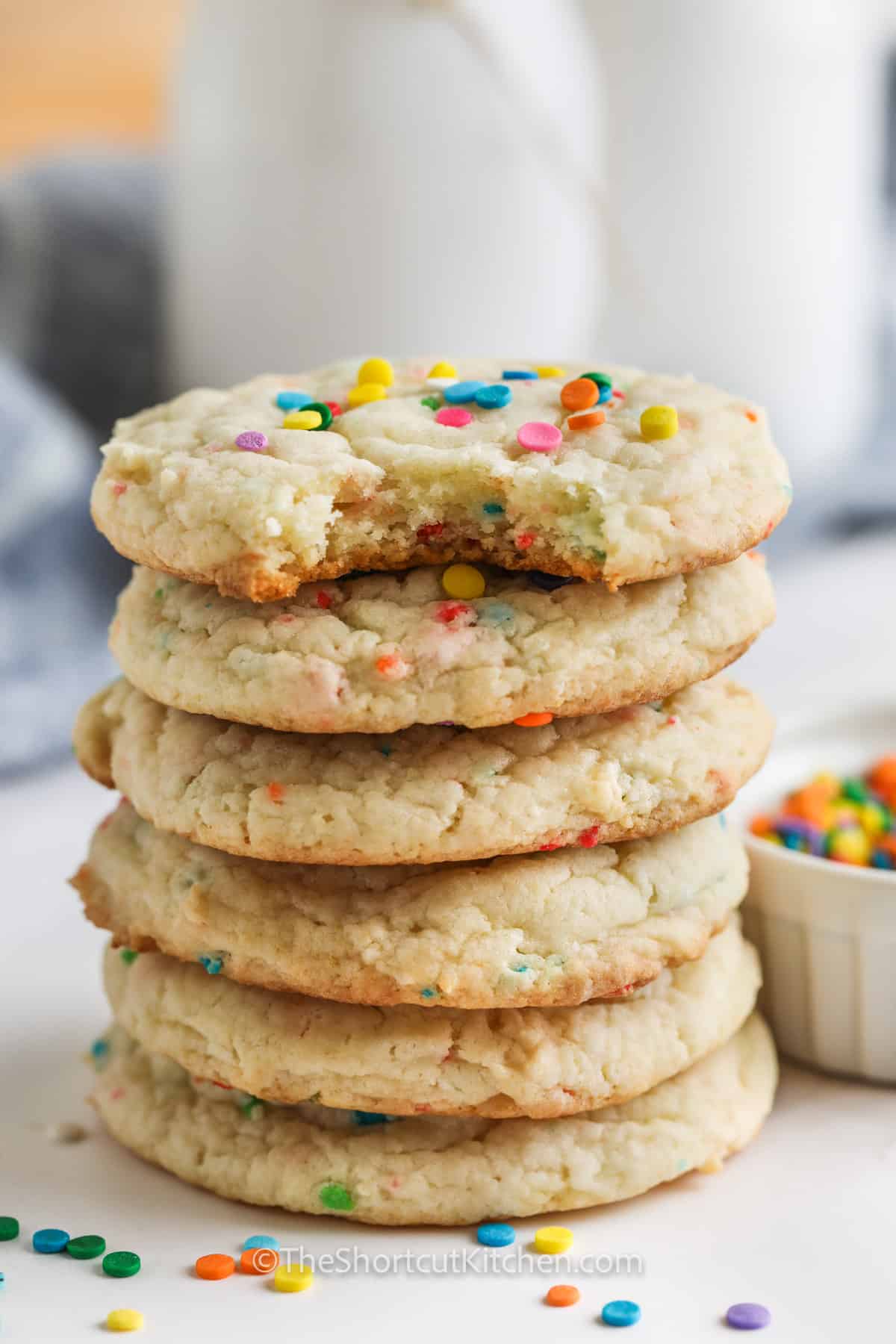 pile of Funfetti Cake Mix Cookies with a bite taken out of one