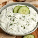 homemade tzatziki sauce with pita bread and cucumber slices