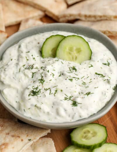 homemade tzatziki sauce with pita bread and cucumber slices