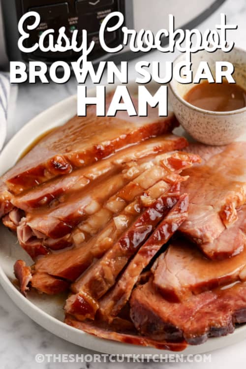 sliced ham on a plate topped with gravy with text