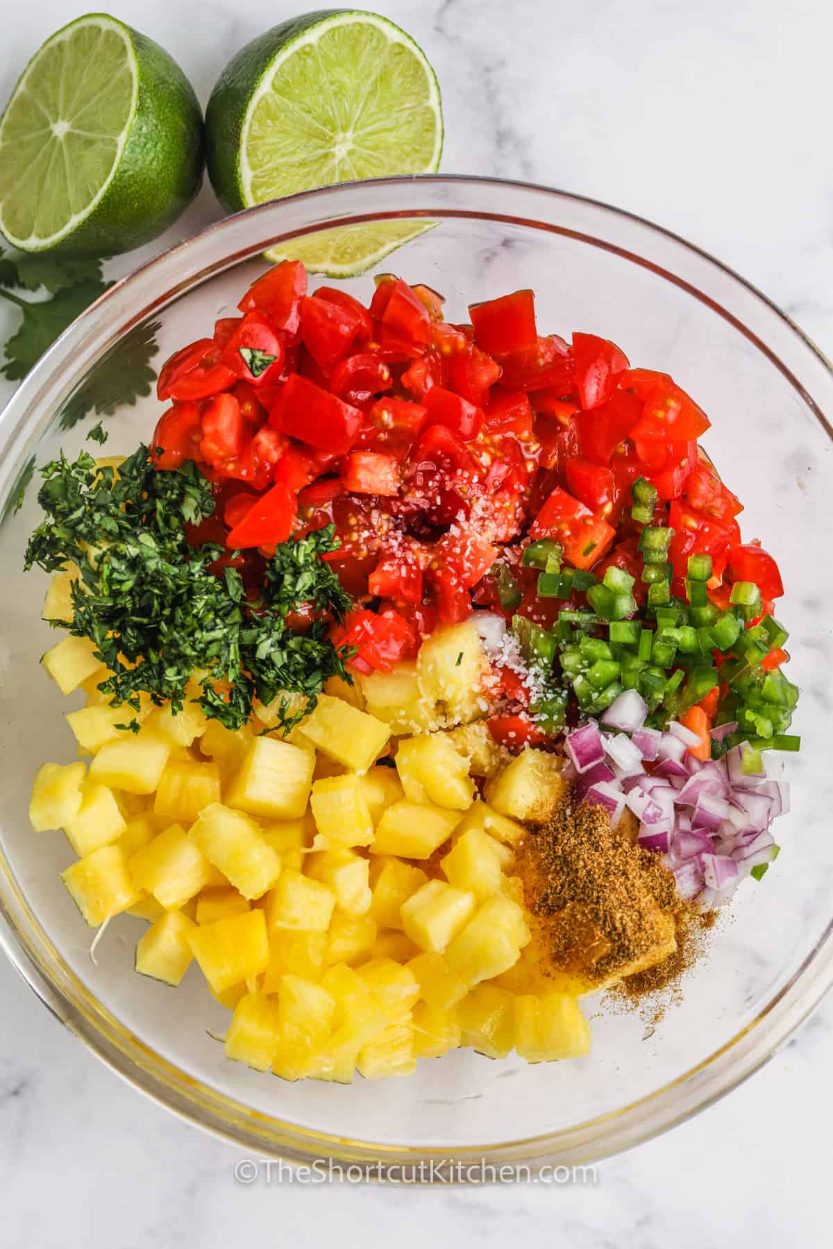 ingredients to make Pineapple Salsa in a bowl before mixing together