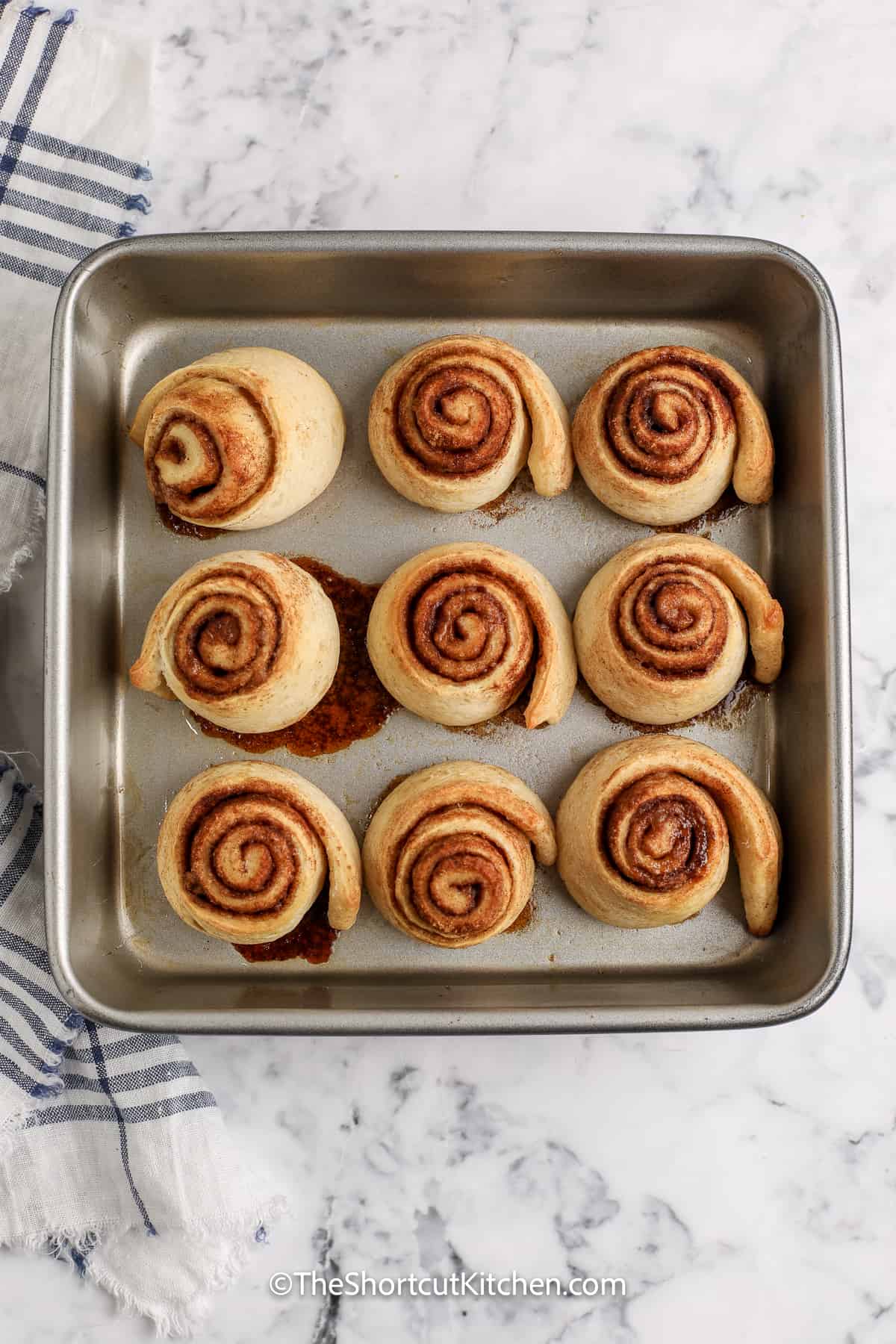 cooked Pizza Dough Cinnamon Rolls in a baking pan