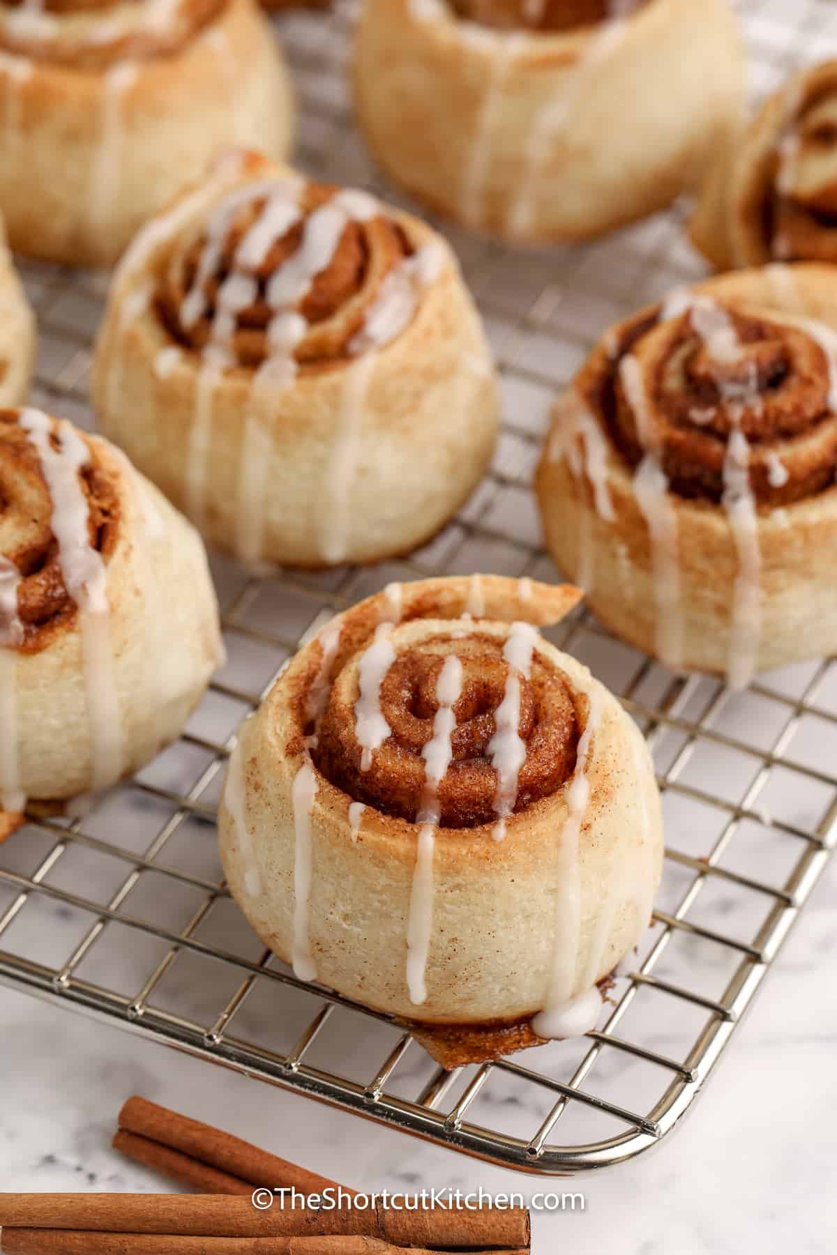 cooked Pizza Dough Cinnamon Rolls on a cooling rack
