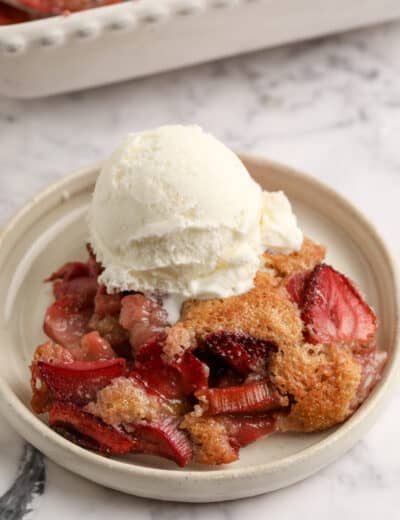 strawberry rhubarb cobbler topped with ice cream