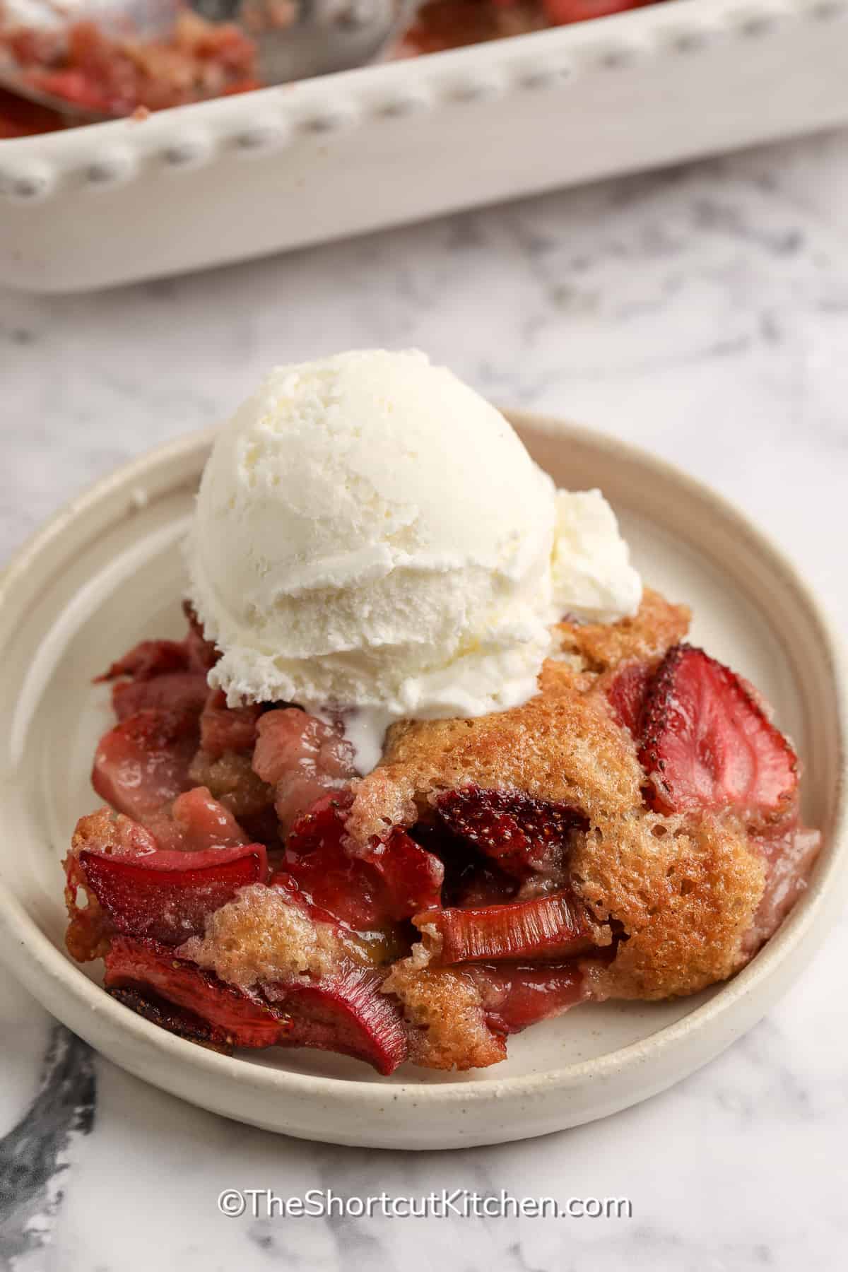 strawberry rhubarb cobbler topped with ice cream