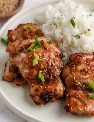 teriyaki chicken thighs on a plate with rice