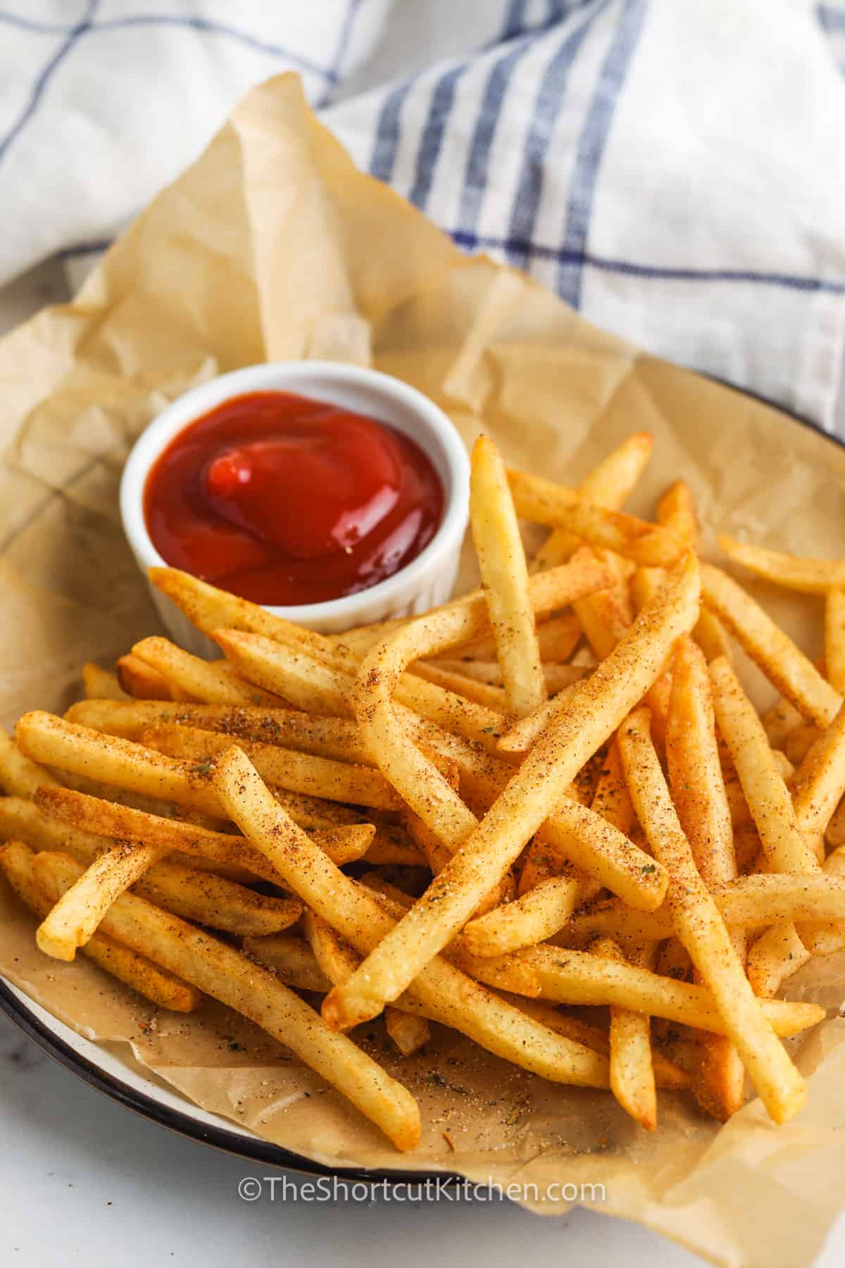 Seasoned French Fries in Paper Bag with Wooden Fork and Ketchup