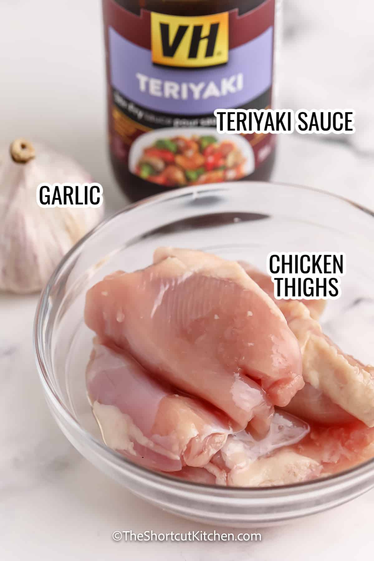 ingredients assembled to make teriyaki chicken thighs, including chicken thighs, teriyaki, and garlic